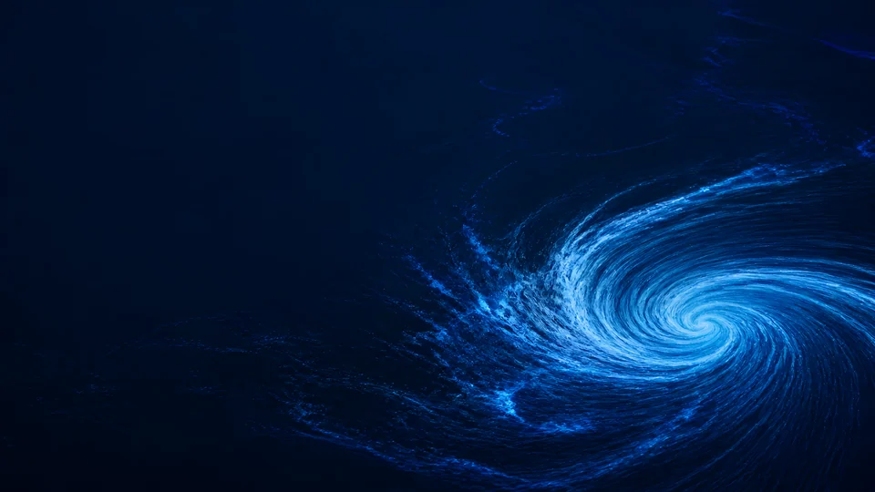 Bioluminescent currents resolve into a single electric-blue curl across a near-black ocean inlet.