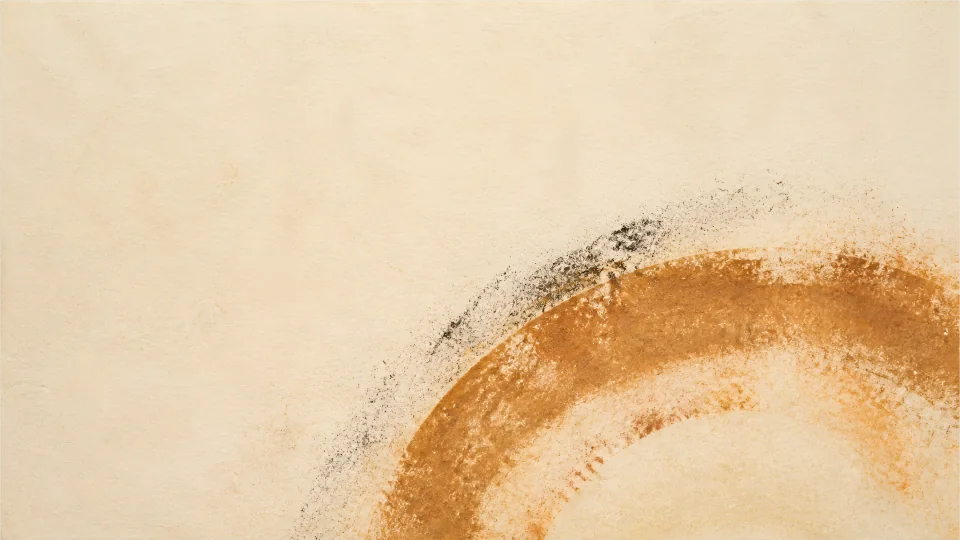 One compressed iron-ochre arc and a charcoal ghost rest on warm, open cotton-rag paper.