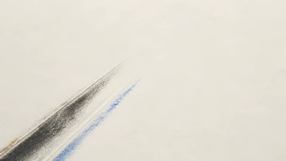 A broad graphite crease and pale pressure echo move diagonally across unmarked bone paper.